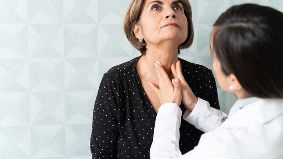 Woman having thyroid examined by an endocrinologist
