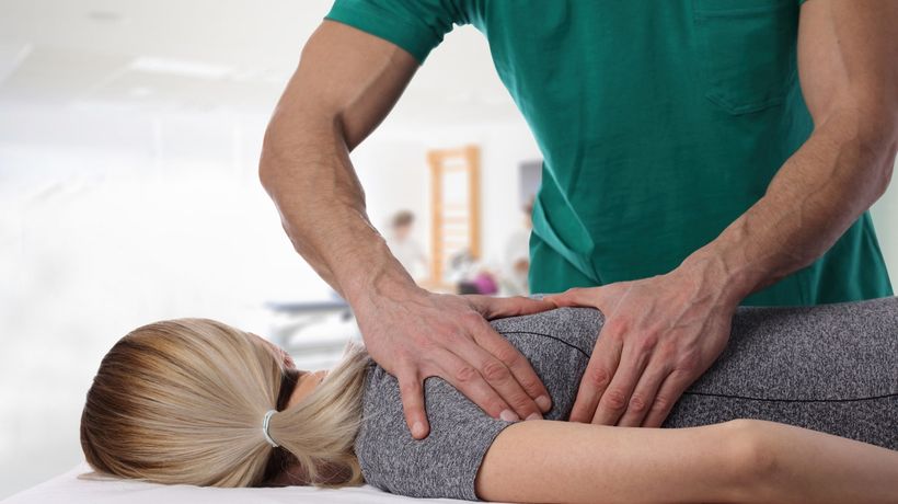 Woman laying on table receiving an adjustment from a Chiropractor or Chiropractic Doctor